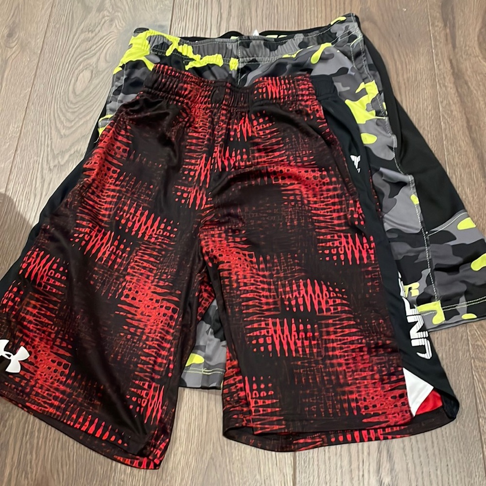two basketball shorts both red are mediums and camp is large